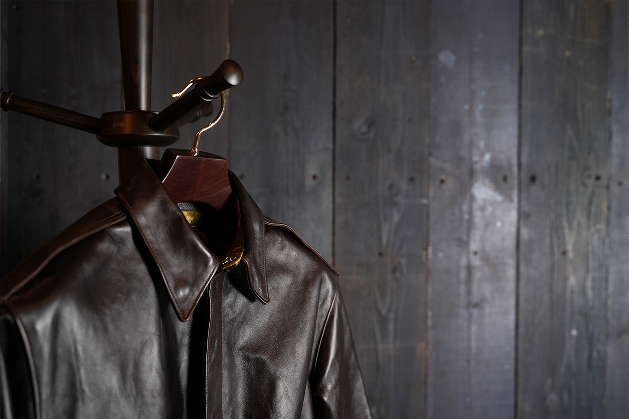 Leather jacket hanging on a wooden hanger